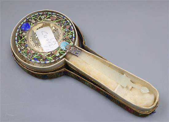 A Chinese white metal and enamel tea strainer, with pierced jade handle, 22cm.